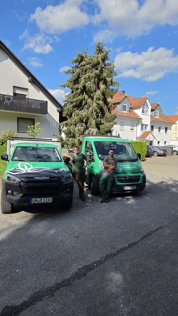Das Team von Hilsmann Gartenservice mit den beiden Firmenwagen